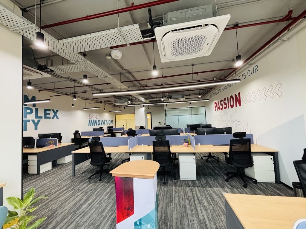 Großraumbüro von SCALE India mit den Leitworten Complexity, Innovation und Passion an der Wand